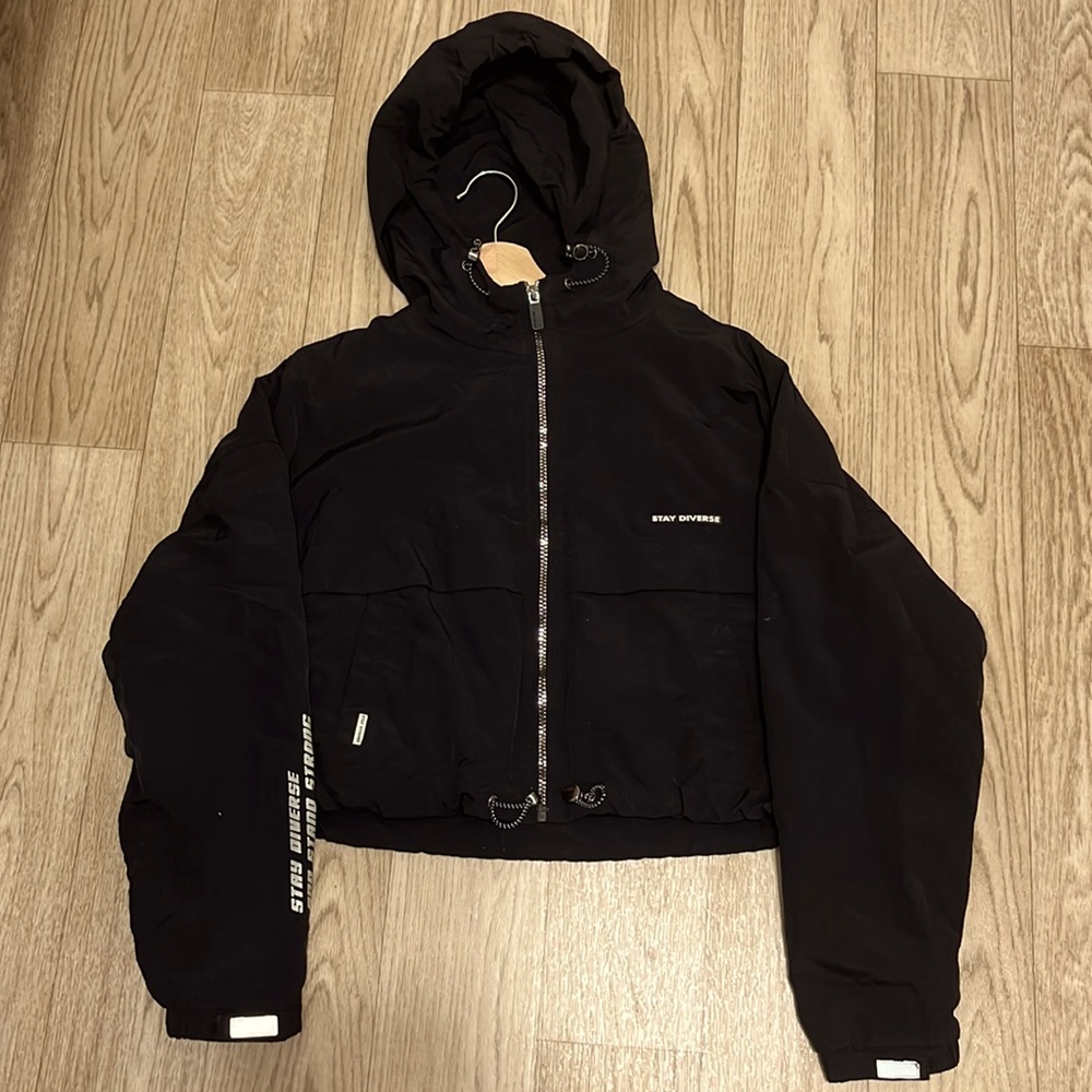 “Stay Diverse” hooded reflective jacket. The fabric is similar to a rain coat.